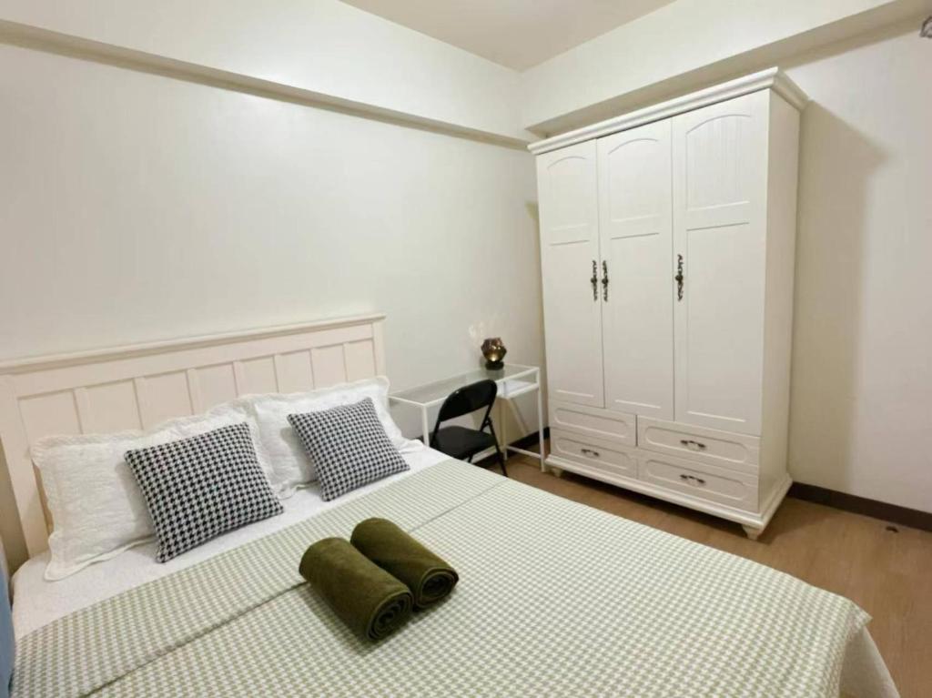 Ένα ή περισσότερα κρεβάτια σε δωμάτιο στο Tan condo city view 01