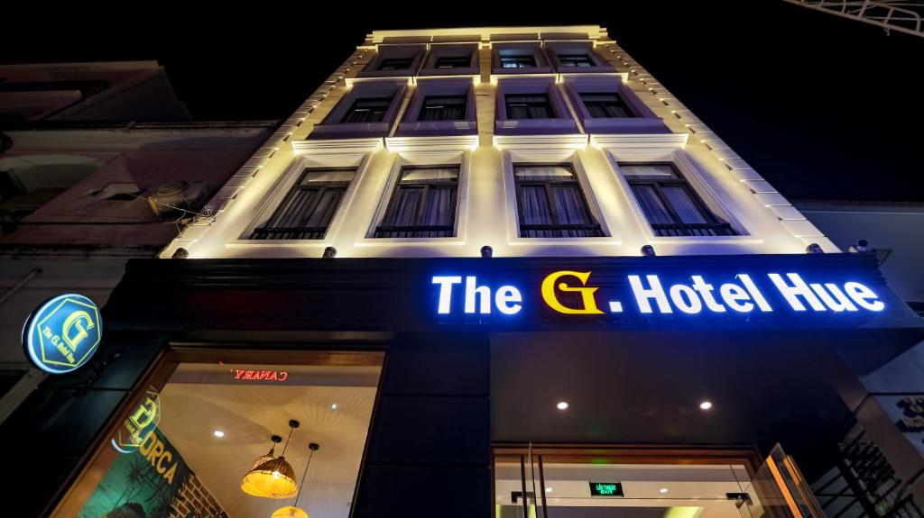 a building with a sign that reads the g hotel hits at The G Hotel Hue in Hue