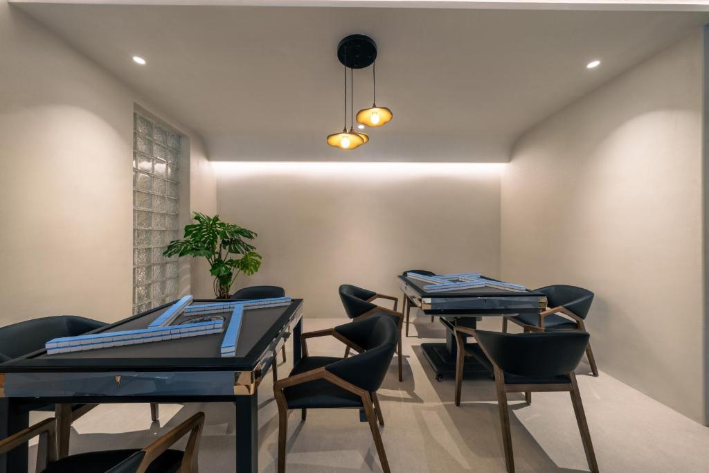 a dining room with two blue tables and chairs at Wild Persimmon Manor Cove Mist Healing Hot Spring in Anji