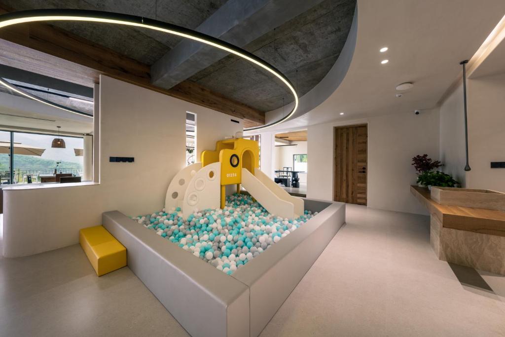 a childrens play room with a slide and a play implement at Wild Persimmon Manor Cove Mist Healing Hot Spring in Anji
