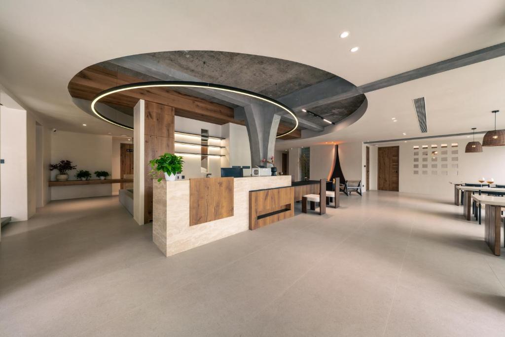 an office lobby with a reception counter and tables at Wild Persimmon Manor Cove Mist Healing Hot Spring in Anji