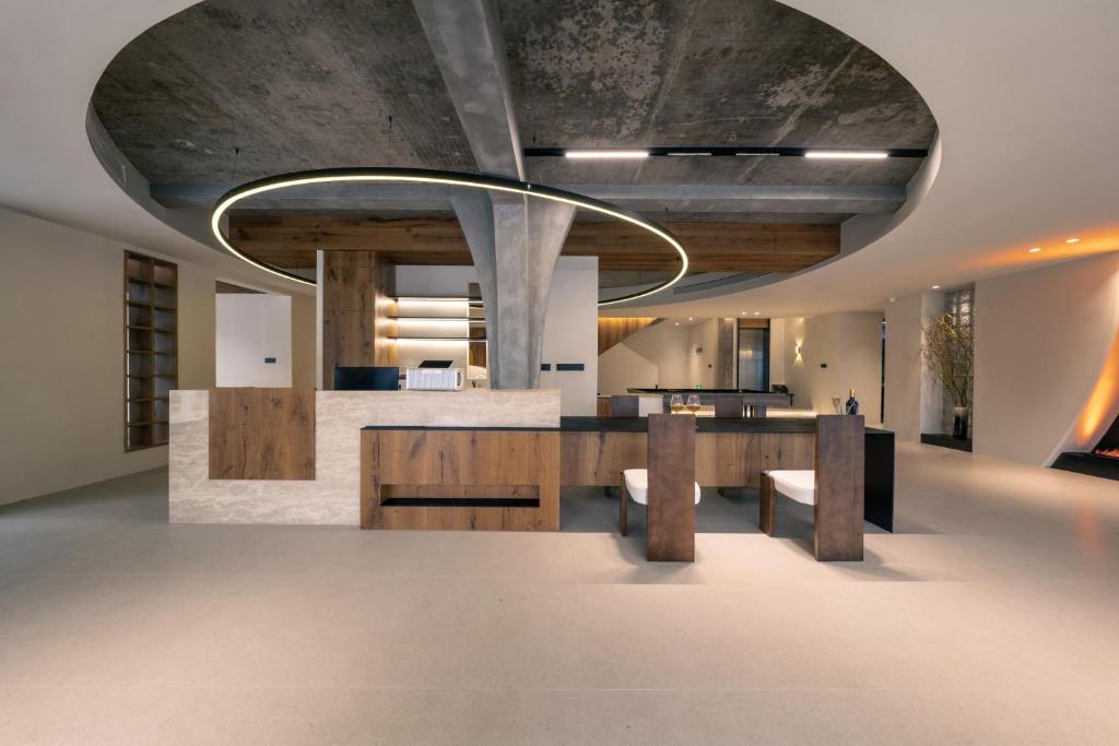 an open kitchen with a concrete ceiling and a table at Wild Persimmon Manor Cove Mist Healing Hot Spring in Anji