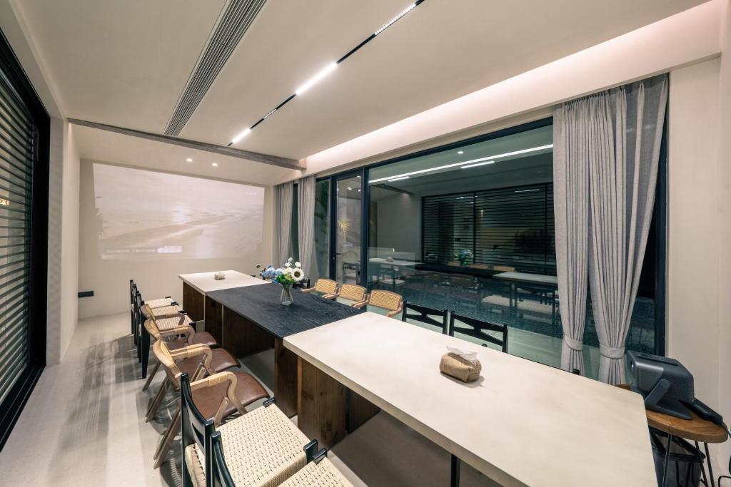 a dining room with tables and chairs and a large window at Wild Persimmon Manor Cove Mist Healing Hot Spring in Anji