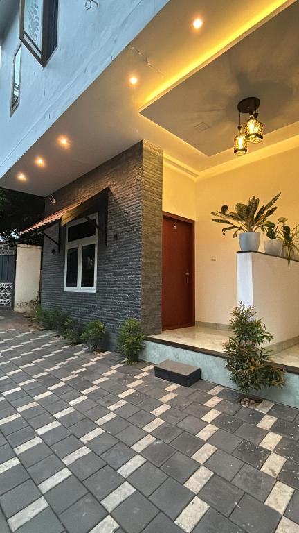 a lobby of a house with a potted plant at GRAYSTONE HOMESTAY, Omassery in Tāzhekkod