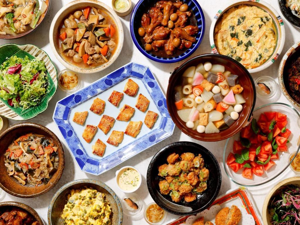a table with many different dishes of food on it at Kanazawa Hakuchoro Hotel Sanraku -Natural Hot Spring- in Kanazawa