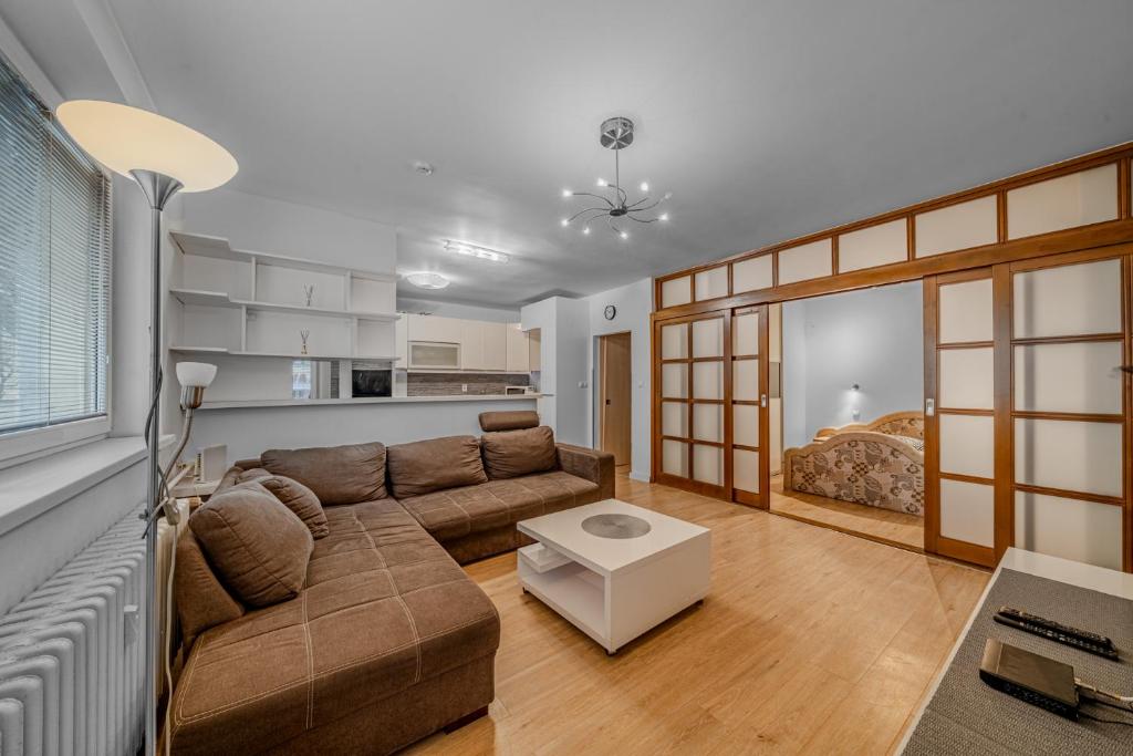 a living room with a couch and a bed at HUGE APARTMENT next to train station close to the city center in Staré Mesto