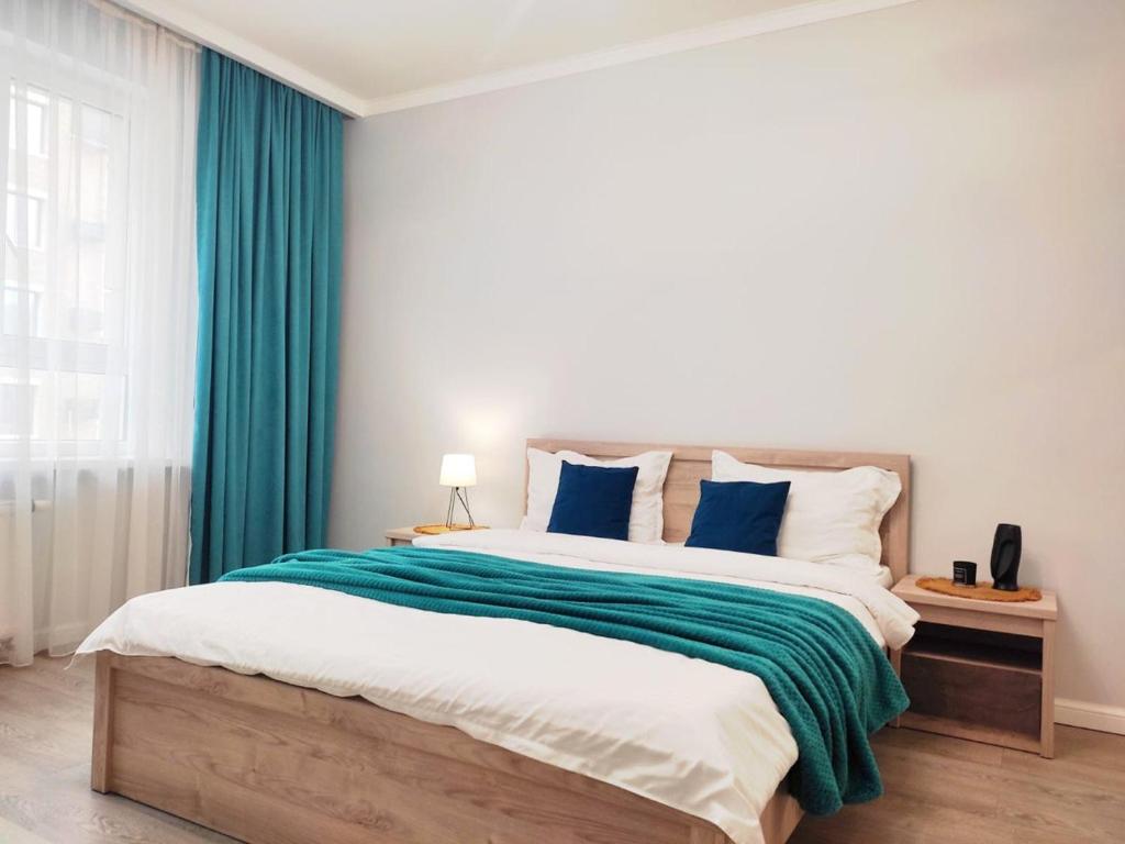 Ένα ή περισσότερα κρεβάτια σε δωμάτιο στο Qonaq Apartments 4YOU 191