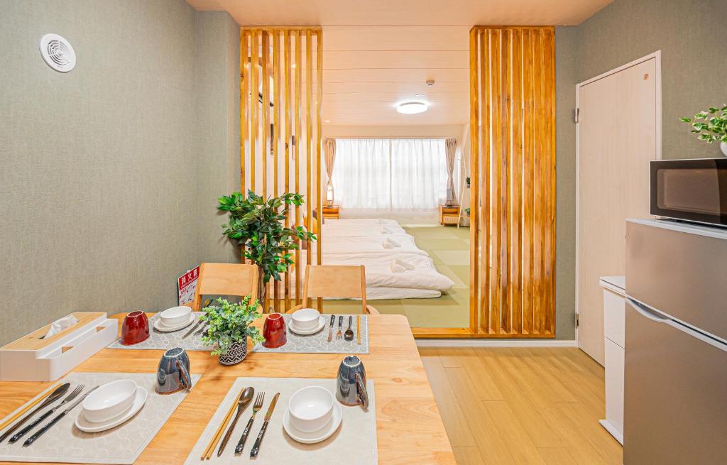 a room with a dining table and a kitchen at Mori hotel Akihabara 1 in Tokyo