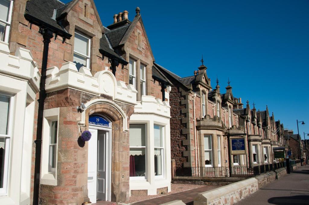 a row of brick buildings on a street at Ardross Glencairn in Inverness