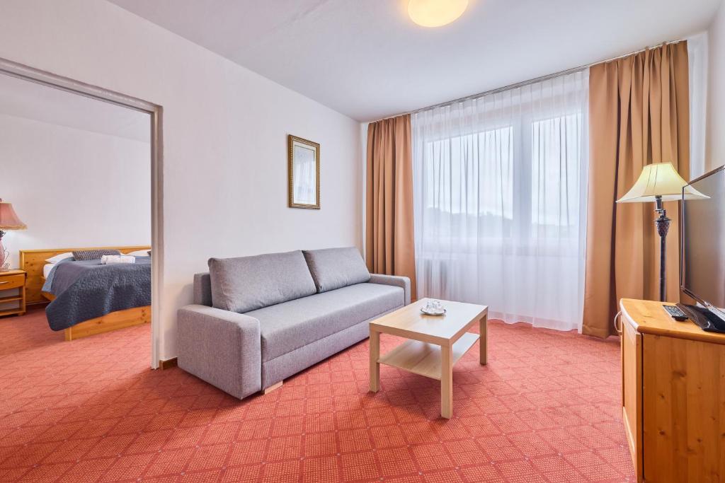 Postel nebo postele na pokoji v ubytování PATRIA HOTEL