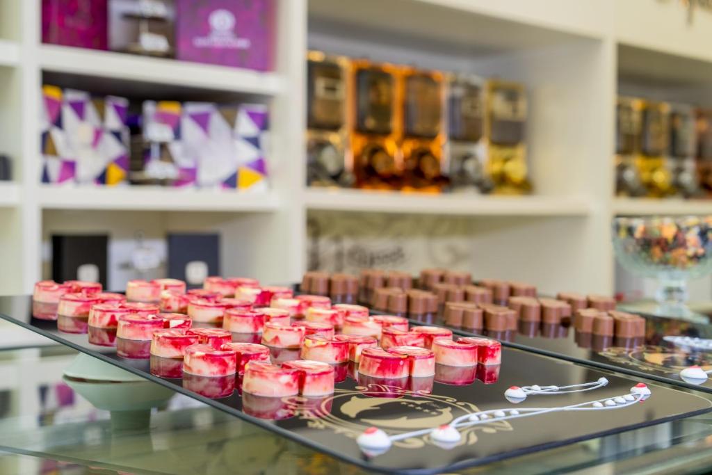 a display case in a store filled with pink candles at Delphin Imperial Lara in Lara