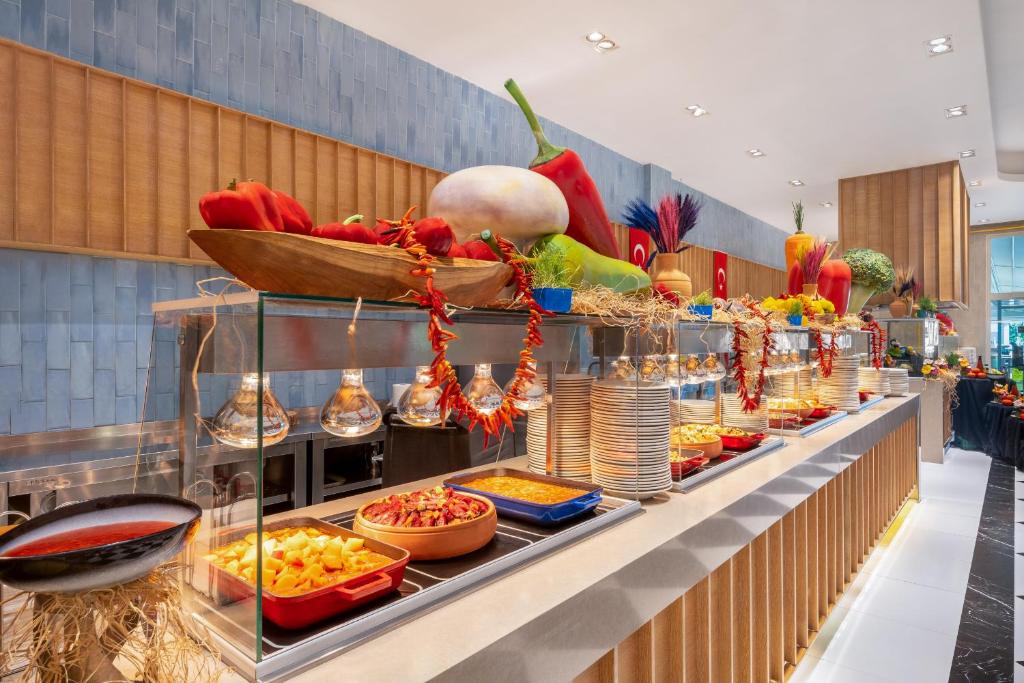 a buffet line with food in a restaurant at Delphin Imperial Lara in Lara