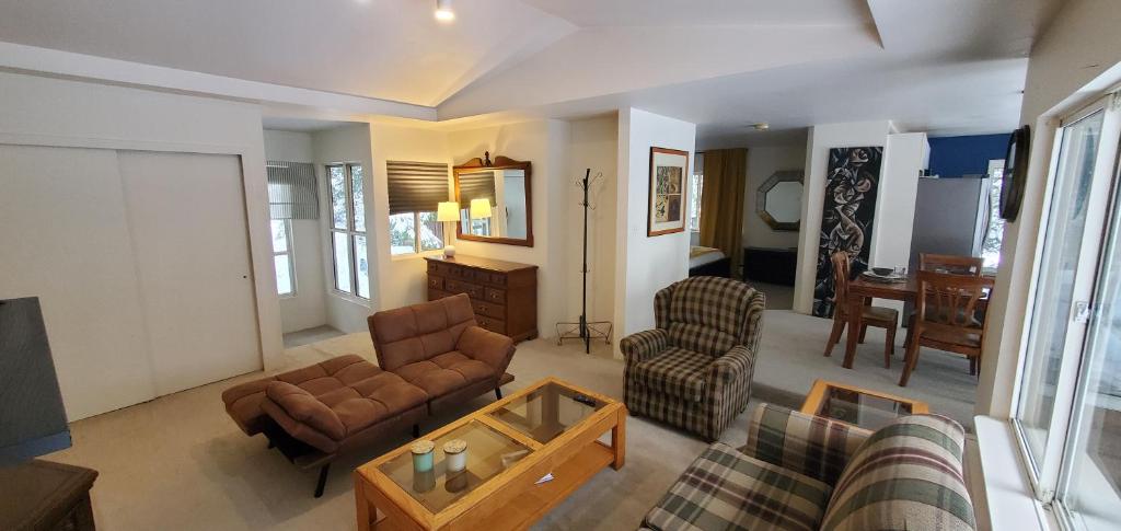 a living room with a couch and chairs and a table at Garden Retreat in West Vancouver in West Vancouver