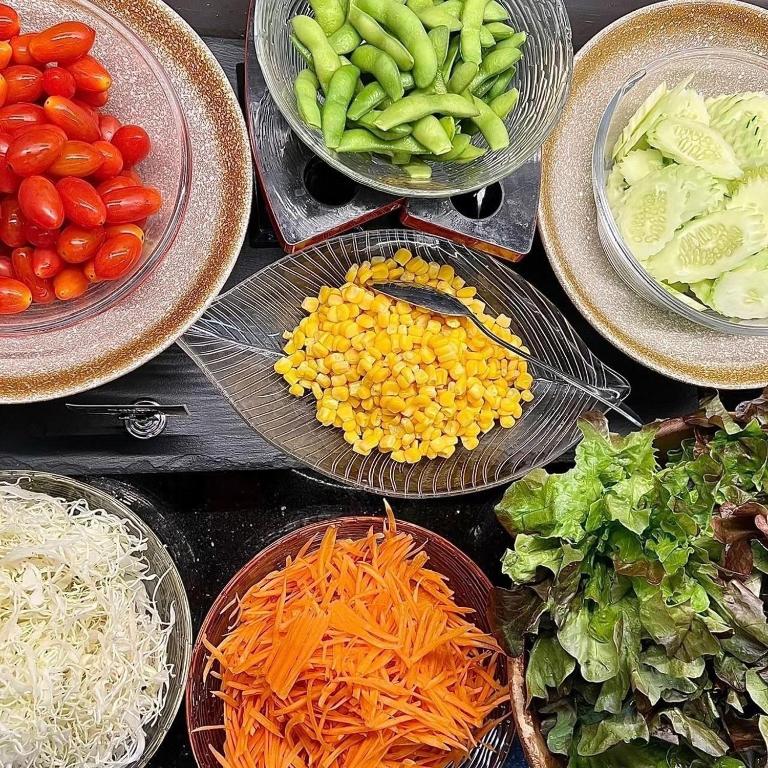 A close-up of a breakfast salad and vegetable station.