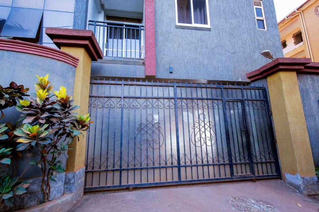 a metal gate in front of a house at Luxury Studio Apartment in Kampala