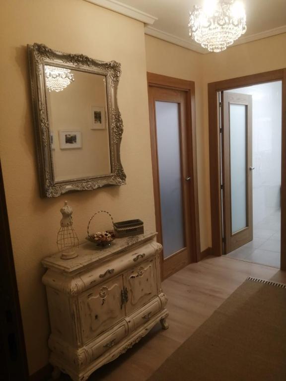 a mirror on the wall above a dresser in a room at El piso de Amalia in Casalarreina