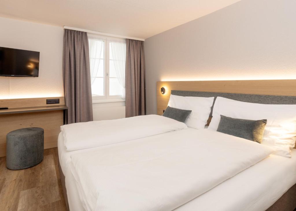 Postel nebo postele na pokoji v ubytování Hotel Restaurant Kreuz