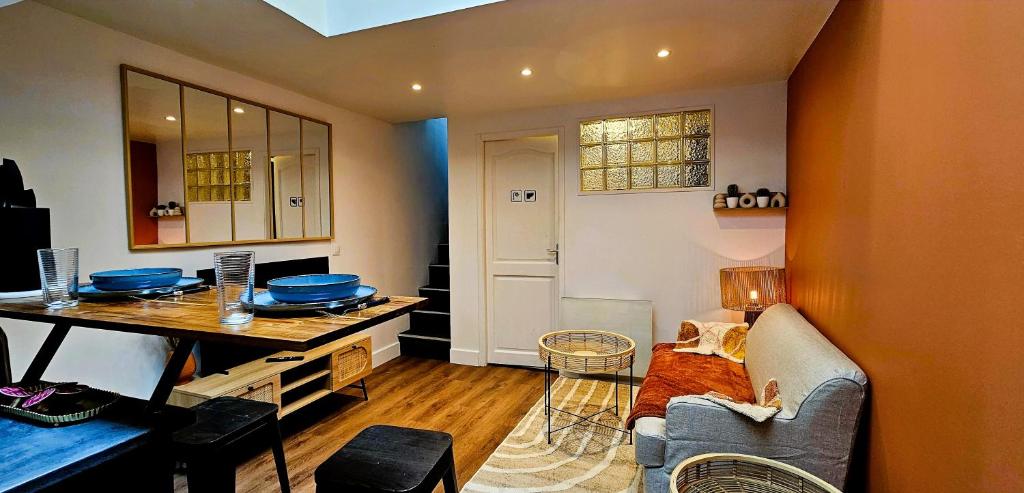 a living room with a couch and a table at La Cachette Oubliée in Melun