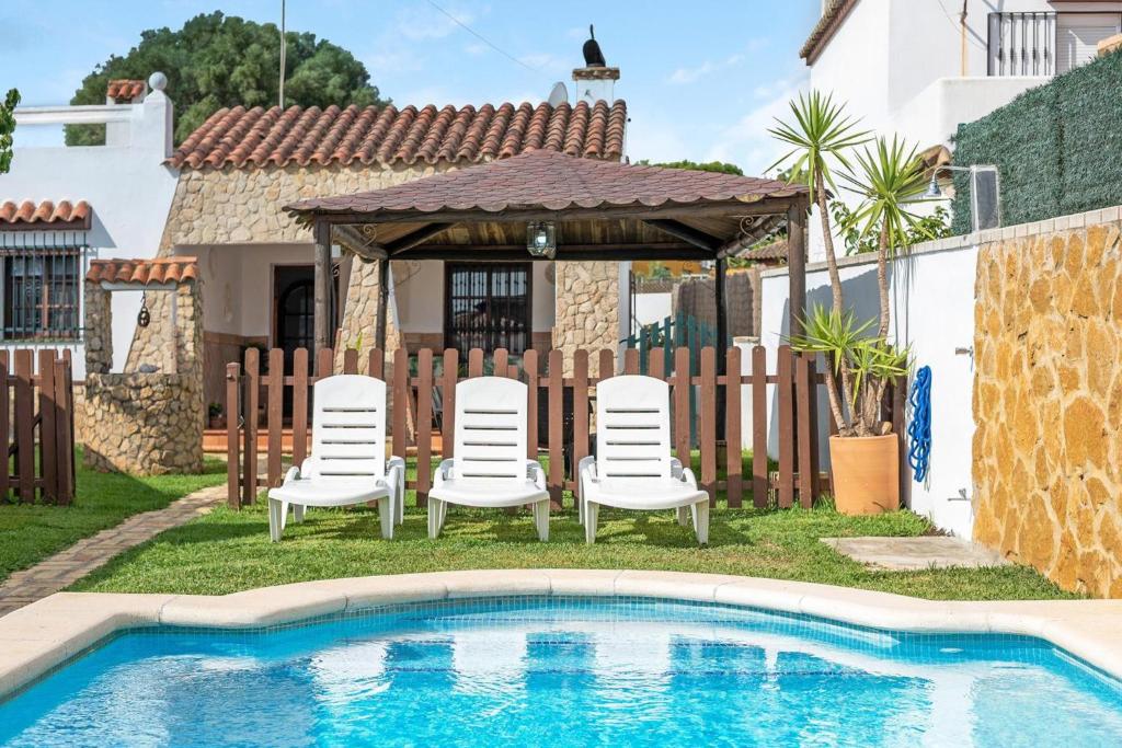 ベヘール・デ・ラ・フロンテーラにあるCasa La Toscanaのプールサイドの椅子とガゼボ