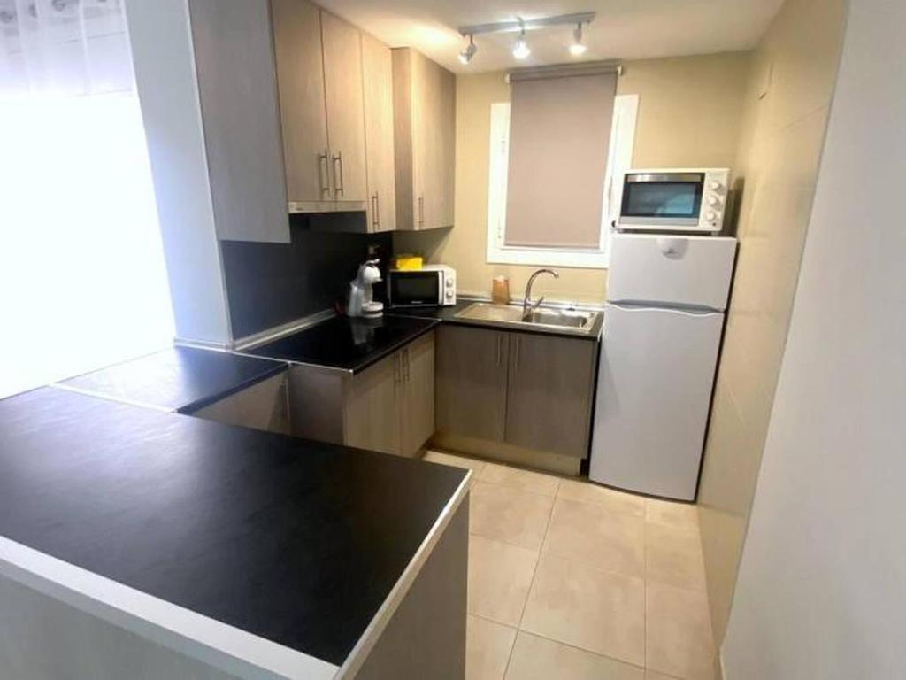 A kitchen or kitchenette at OLIMPE 2 8