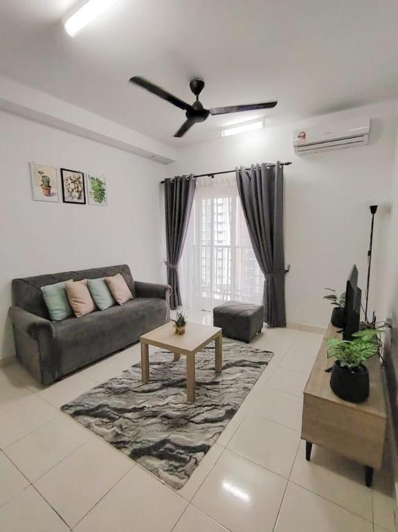 a living room with a couch and a table at Aurora's Place at Alanis Residence in Sepang
