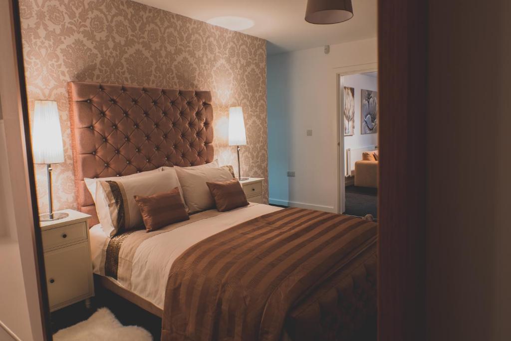 a bedroom with a large bed and a mirror at Discovery Suite – Simple2let Serviced Apartments in Halifax