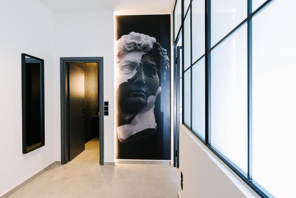 a bust of a man on a wall in a hallway at G Residence in Athens