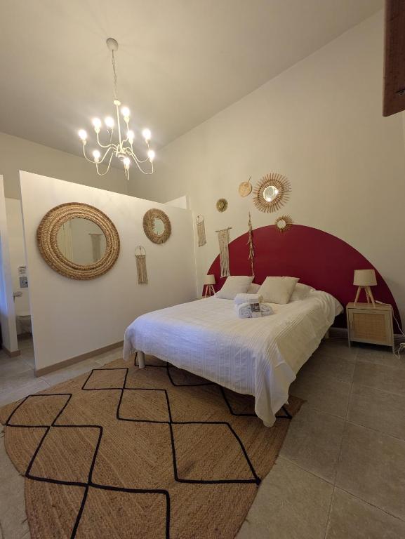 a bedroom with a large bed and a large mirror at Château Sainte Colombe in Saint-Geniès-des-Mourgues