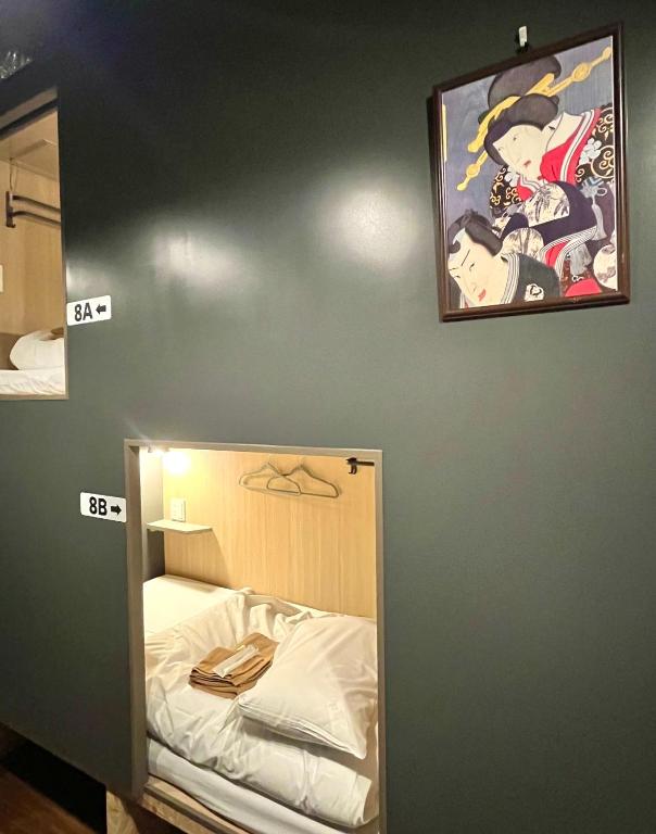 Postel nebo postele na pokoji v ubytování Yoroi Asakusa Hotel