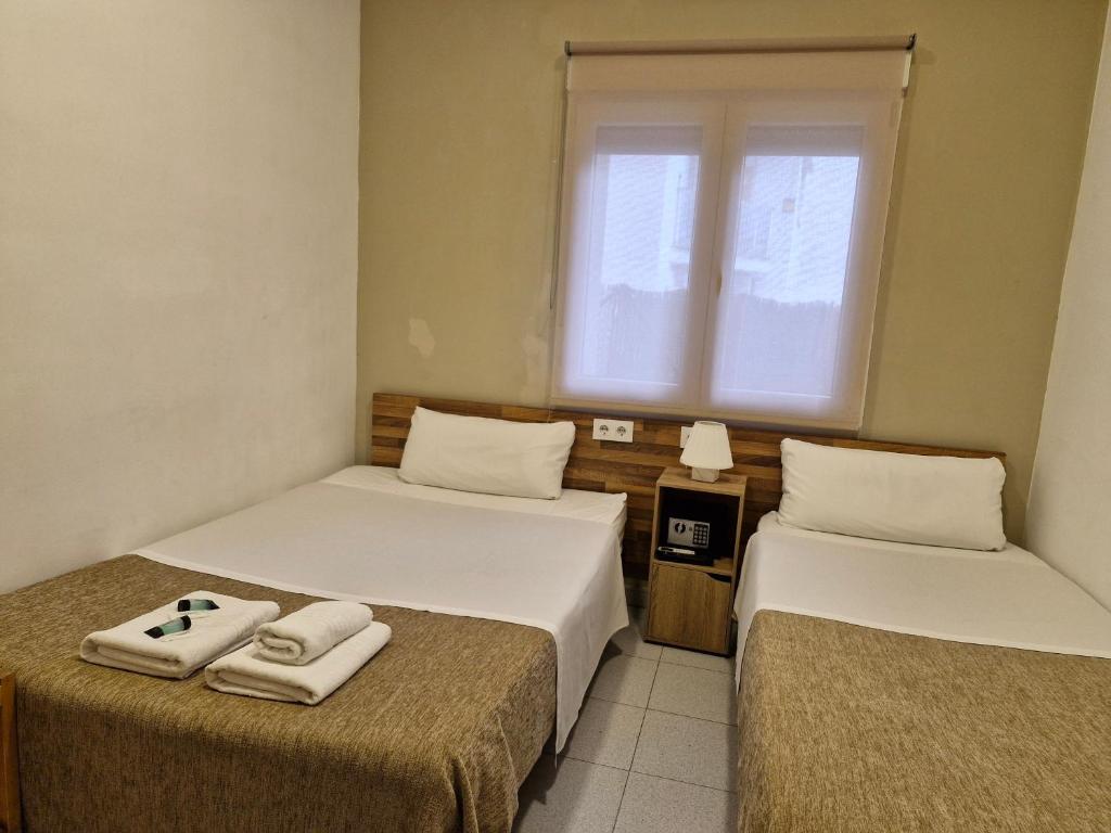 Postel nebo postele na pokoji v ubytování Hostal Elkano