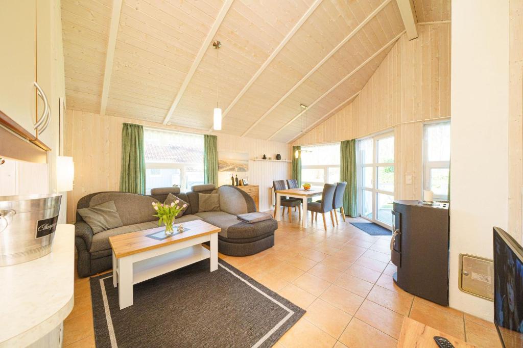 a living room with a couch and a table at Ferienhaus Otter in Otterndorf