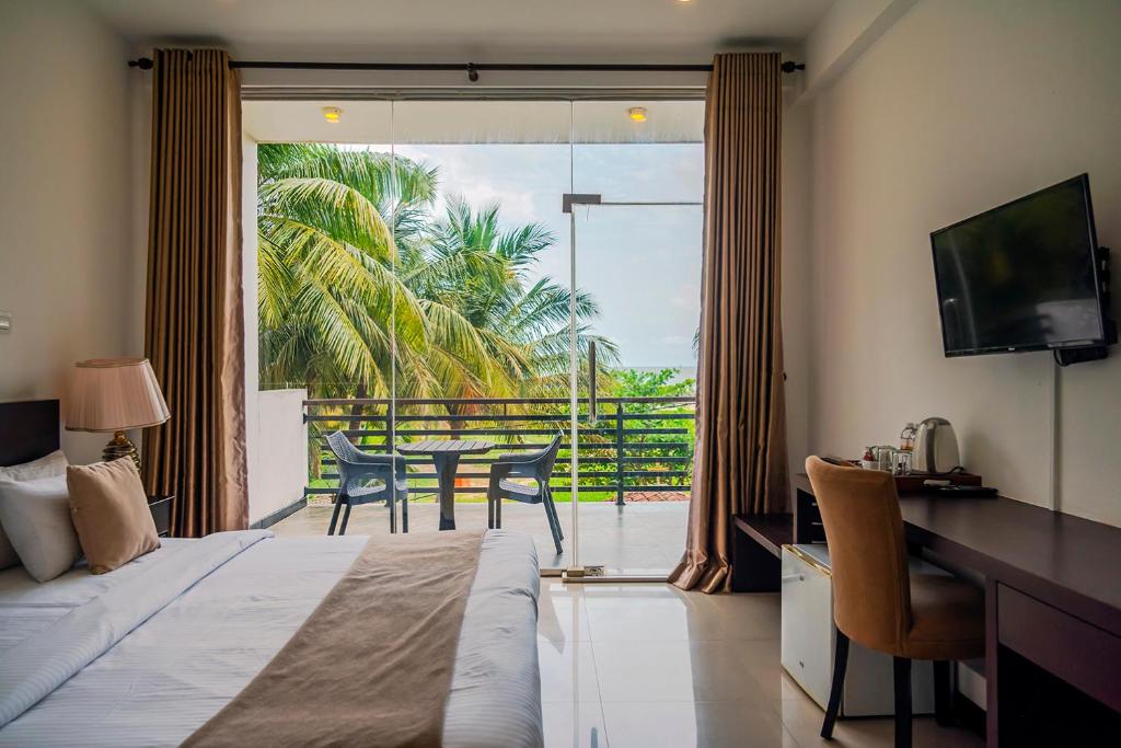 Postel nebo postele na pokoji v ubytování Beverly Beach Negombo