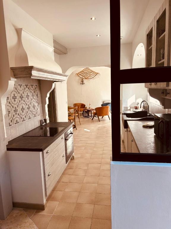 a kitchen with a counter and a dining room at "ENTRE LA VIGNE et L'OLIVIER" in Taulignan