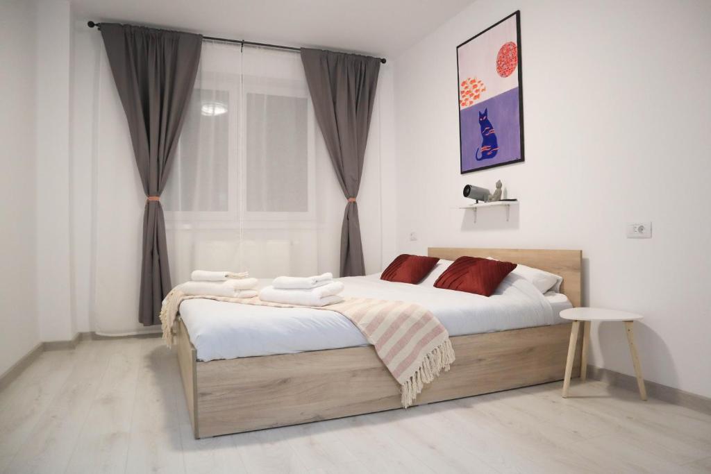 a bedroom with two beds and a window at LZR - Apartment 57 in Braşov