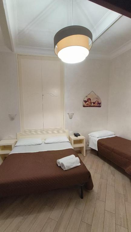 Postel nebo postele na pokoji v ubytování Hotel PRINCIPE AMEDEO