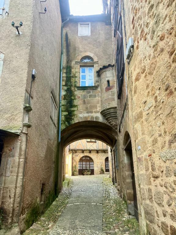 an alleyway in an old building with a window at Paloma in Figeac