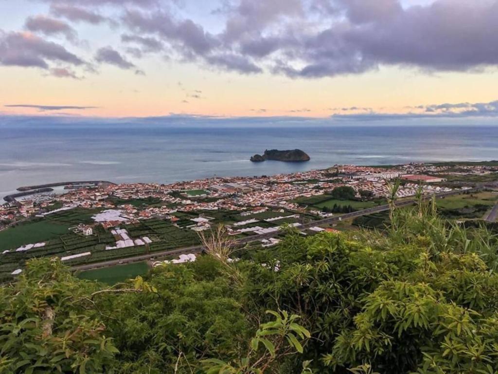 an aerial view of a city and the ocean at Maré Baixa - Cozy Seaside Stay in Vila Franca do Campo
