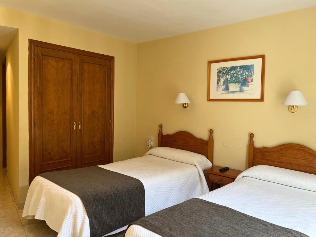 Postel nebo postele na pokoji v ubytování Hotel Juan Canejan