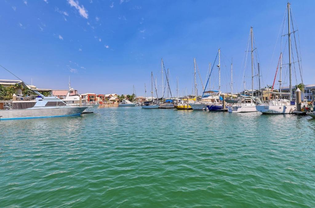 a group of boats are docked in a harbor at Marina Views Cozy 3br Villa In Tipperary Waters in Stuart Park