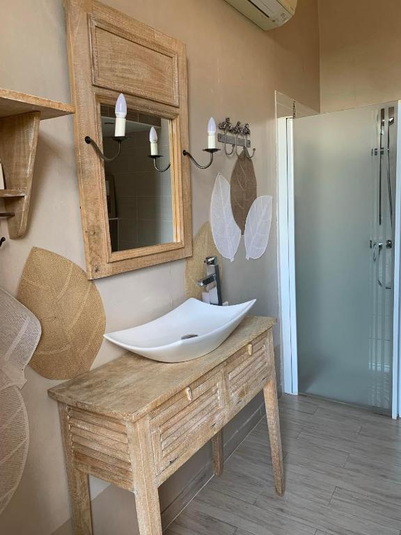 a bathroom with a sink and a mirror at Château Sainte Colombe in Saint-Geniès-des-Mourgues