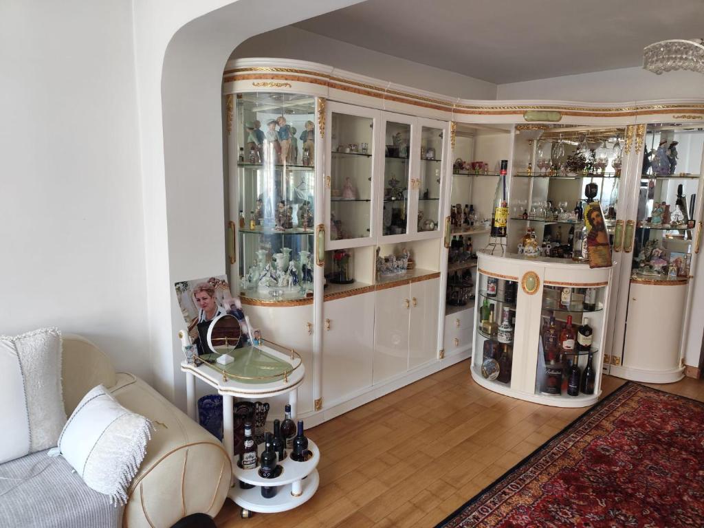 a living room filled with lots of glass cabinets at Vila Elena in Bucharest