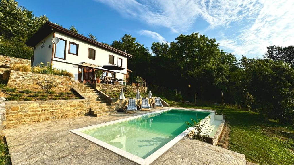 a swimming pool in front of a house at Vista Verde in Oreshak