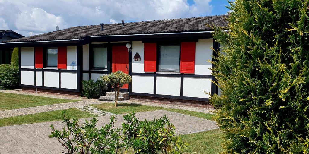 a house with red and white paint on it at Ferienhaus Schöps in Burhave
