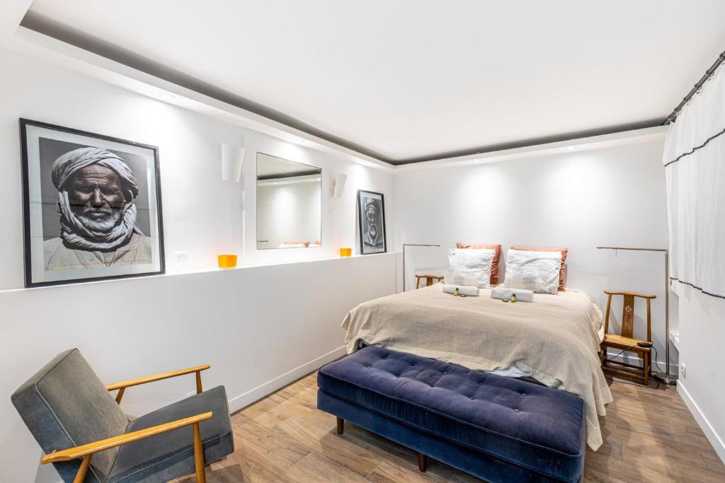 une chambre avec un lit et un canapé bleu dans l'établissement GuestReady - Modern retreat near the Eiffel Tower, à Paris