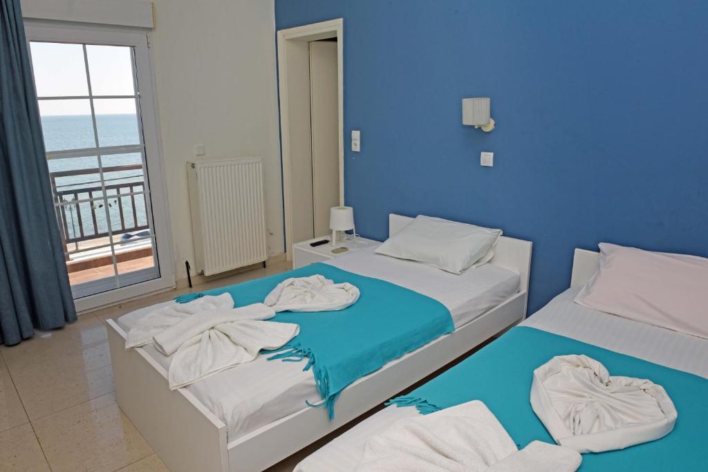 Postel nebo postele na pokoji v ubytování Star Beach Resort - Makrygialos Beachfront Nests
