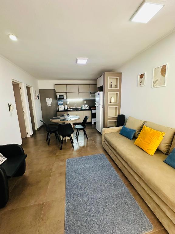 a living room with a couch and a table at SOMBRAS DEL PARANA Apart Misiones in Eldorado