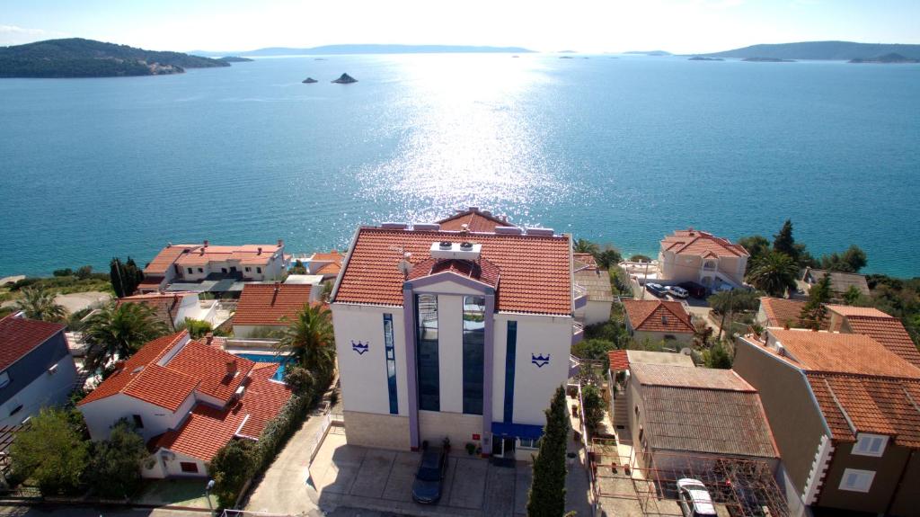 an aerial view of a house and the water at Hotel Viktorija in Seget Vranjica