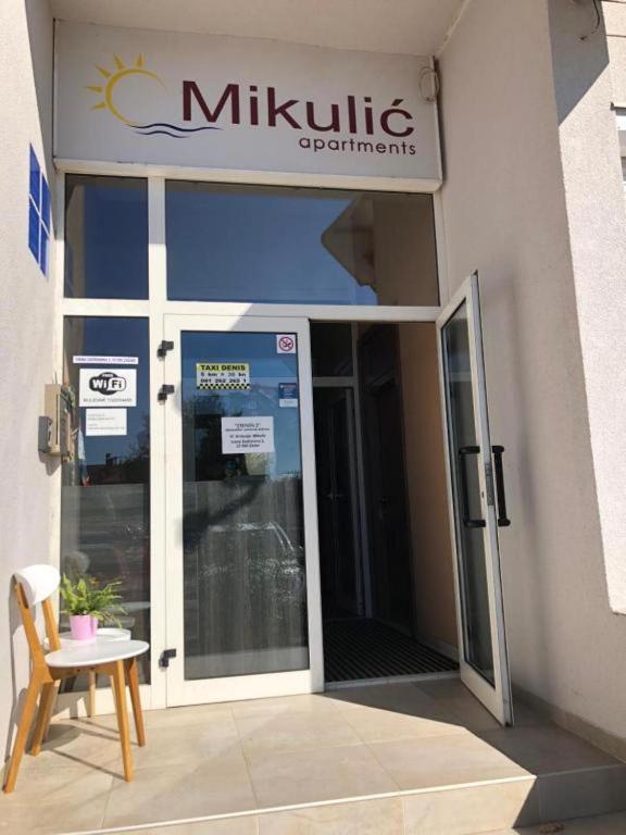 an entrance to a mitzvah building with a revolving door at Mikulić Apartments in Zadar