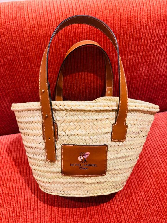 a white purse sitting on top of a red couch at Hôtel Gabriel in Menton