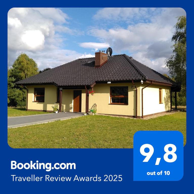a house with a tiled roof on top of it at Dom Wakacyjny Kuszewo in Czaplinek